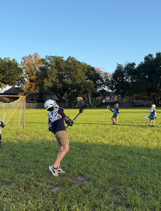 Young athletes celebrating lacrosse play