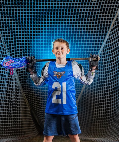 Girls lacrosse players running downfield